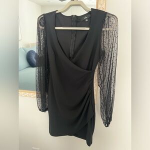 Lulus little black dress with sheer polka dot sleeves.